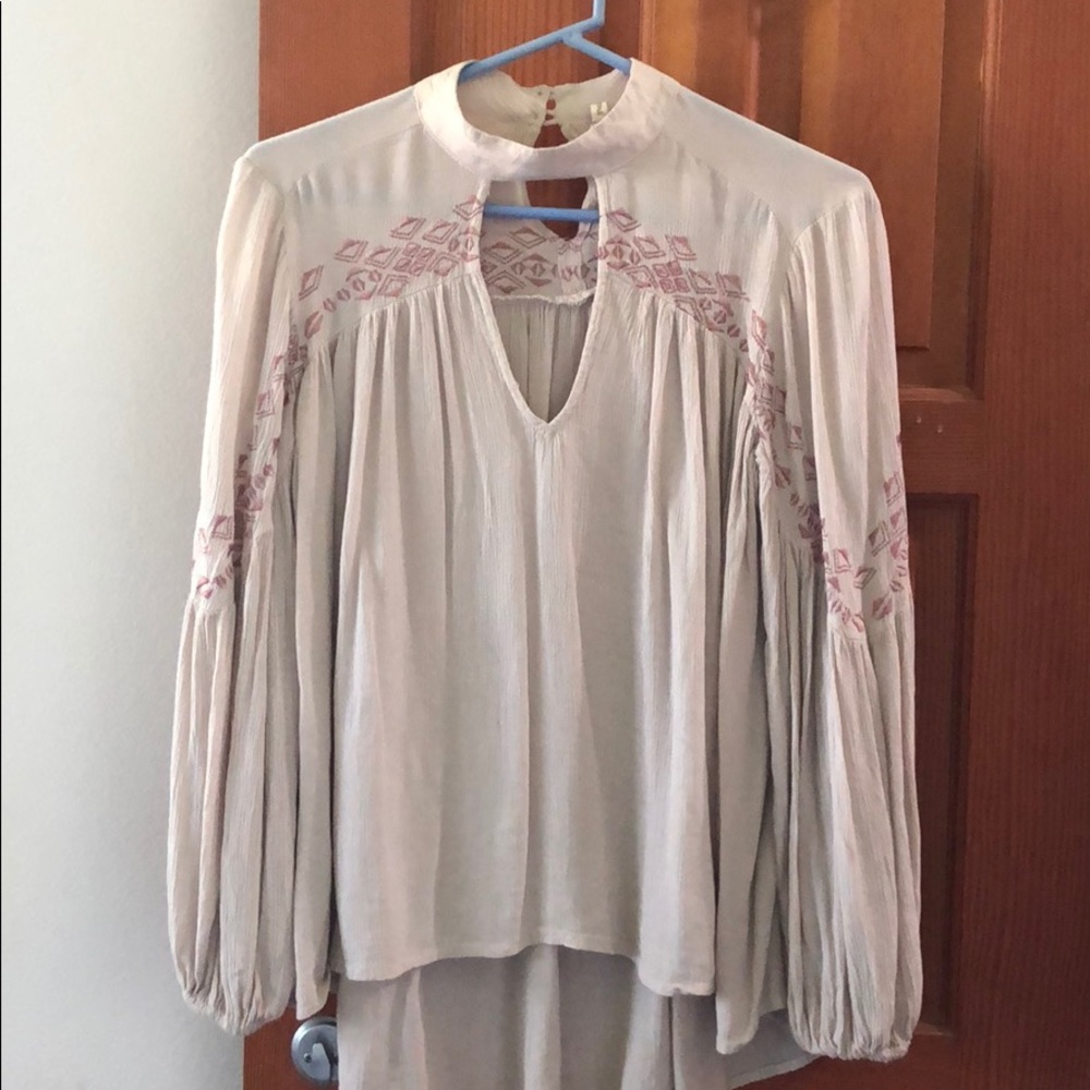 Tan blouse with key hole neck.